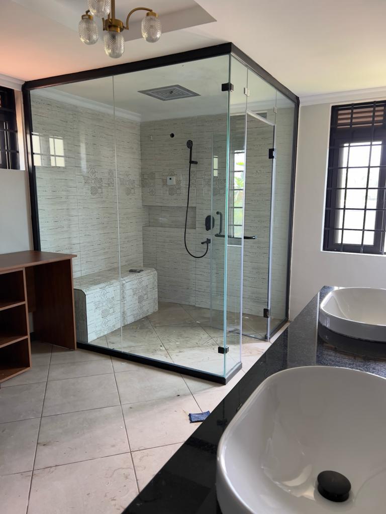 Frameless glass shower enclosure and freestanding bath