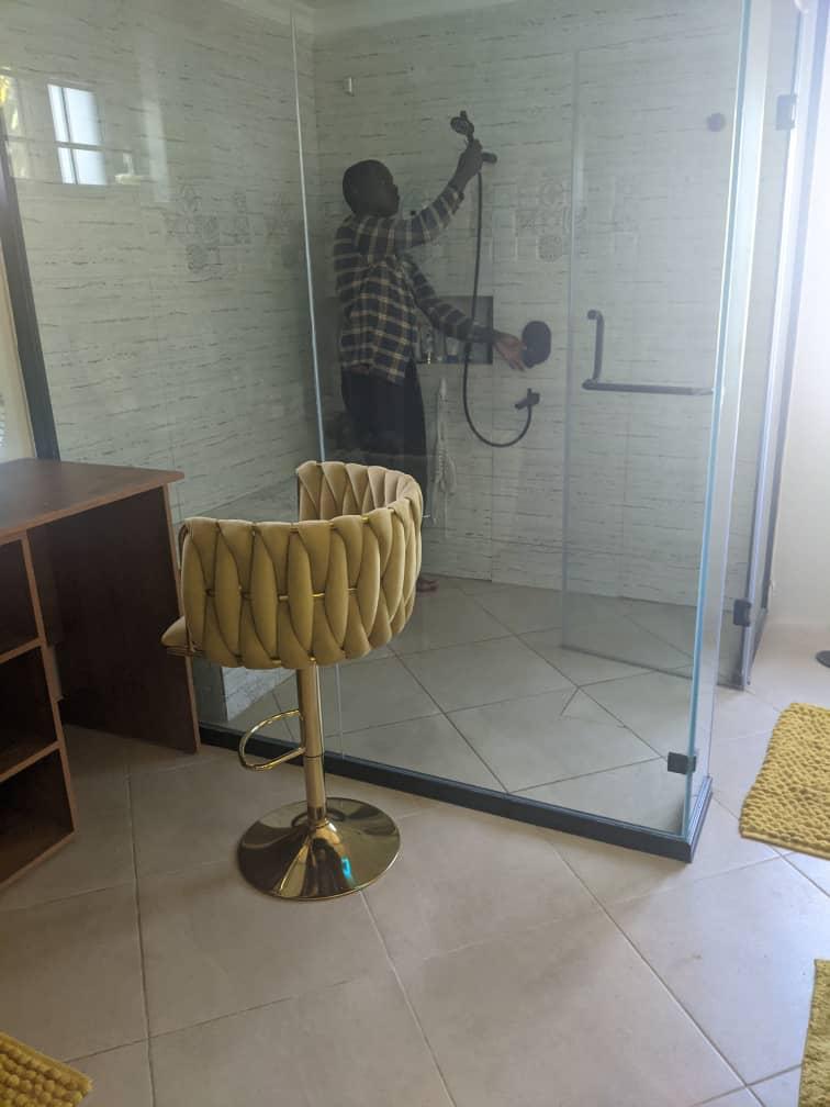 Technician installing glass shower system