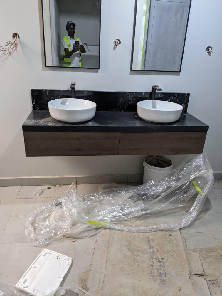 Contemporary floating vanity with dark square vessel sink