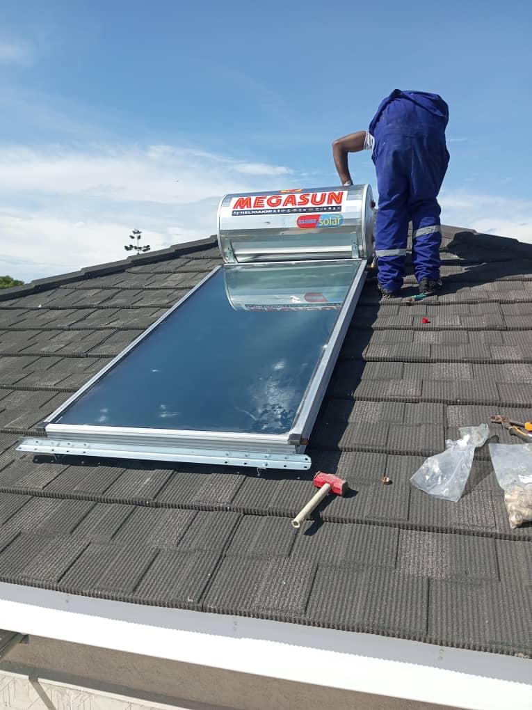 Megasun solar water heater on dark shingle roof